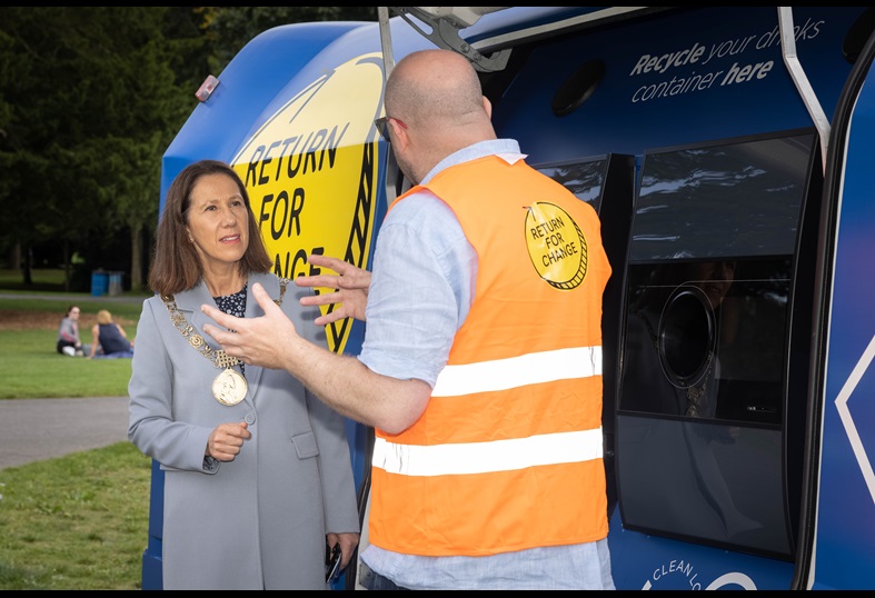 image of a lady mayor and a man explaining something to her