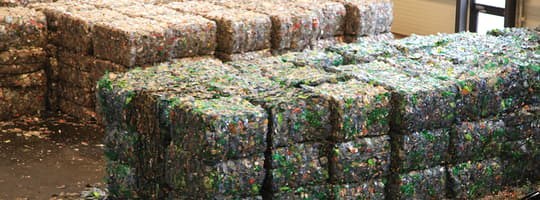 Cubed bales of compacted plastic bottles