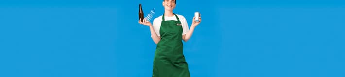A woman in a green apron holds used beverage containers on a blue background